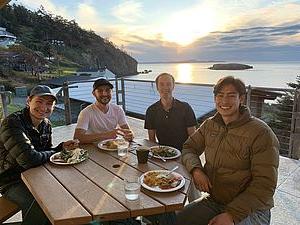 Photo of students eating at the beach